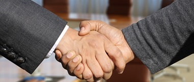  Zwei Hände, die sich die Hand geben. 